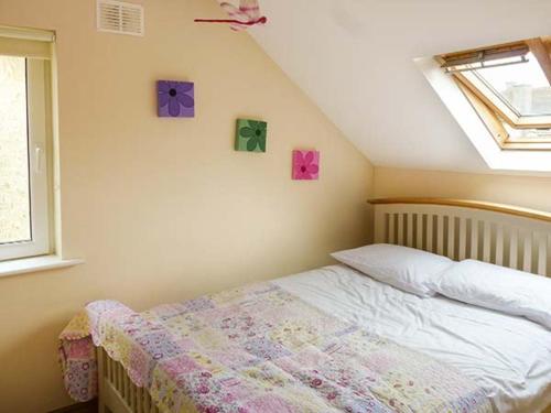 a bedroom with a bed in a room with a window at Lovers' Lodge in Kilkenny