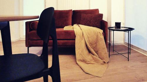 a living room with a couch with a blanket at Apartamenty Białystok - Apartment Royal VI in Białystok