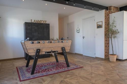 a wooden table in a room with a door at L'annexe Morbecque in Morbecque
