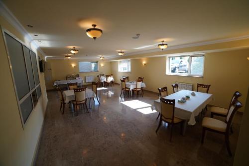 KapanSyunik Hotel的餐厅里有桌椅的餐厅