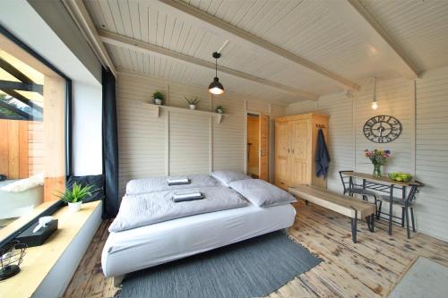 a bedroom with a bed and a table in a room at Apartmán Malá Skála in Malá Skála