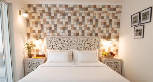 a bedroom with a white bed with two night stands at Ru Boutique in Kandy