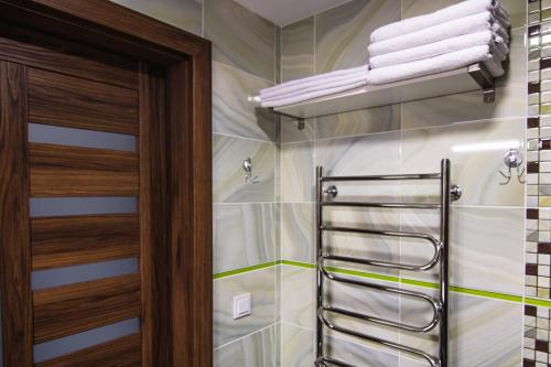 a bathroom with a towel rack next to a shower at Garden Cottage in Palanga