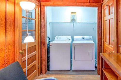 a kitchen with a washer and dryer in a house at Charlotte's Cabin in Waynesville