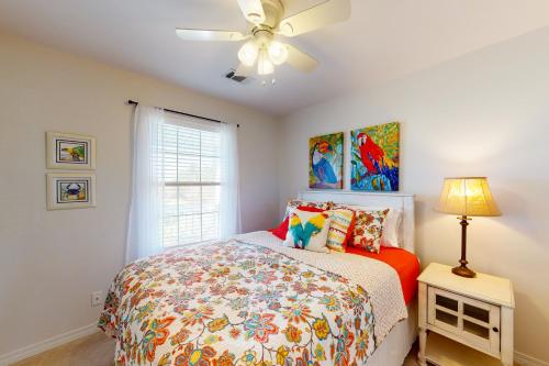 a bedroom with a bed and a ceiling fan at 21 Palms in Gulf Shores