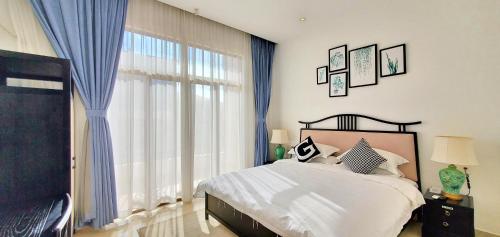 a bedroom with a bed and a large window at Sanya Haitangwan Shang Gong Yuan She Wellness Resort Villa in Sanya