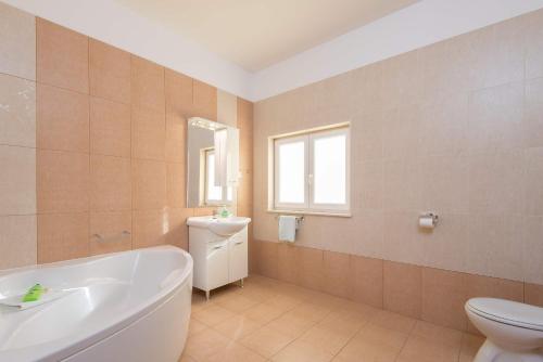 Un baño con bañera, inodoro y lavabo. en Apartment Prižba - Korčula, en Prizba