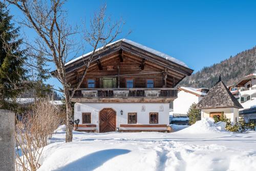 a house in the snow with a roof at Hotel Jagdschlössl in Kirchdorf in Tirol