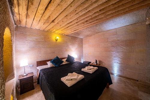 A bed or beds in a room at Tabal Cave Hotel