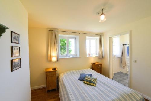 a bedroom with a bed with two pillows on it at Ferienwohnung 1 mit schönem Seeblick in Neuenkirchen