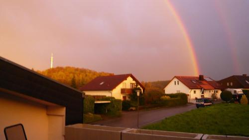 a rainbow in the sky over a house at Ferienwohnung Sinsheim-Dühren in Sinsheim
