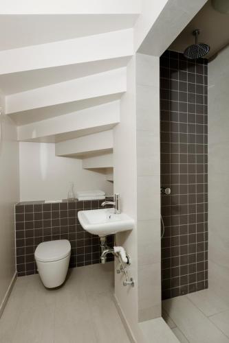 a bathroom with a sink and a toilet at Old Charm Reykjavik Apartments in Reykjavík
