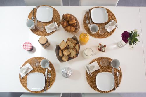 a table with wicker baskets and bread on it at MAISON MAUPAS Chambre Rouge in Bellesserre