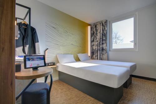 Postel nebo postele na pokoji v ubytování B&B HOTEL Epernay