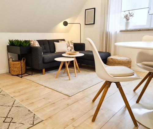 a living room with a couch and a table and chairs at Mirielle Apartments in Rust