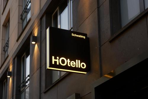 a hotel sign on the side of a building at HOtello Schwabing in Munich