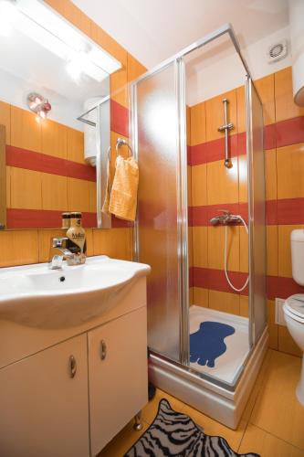 a bathroom with a shower and a sink at Beachfront villas Pinky-Superior heated pools and jacuzzi just 25 m from see in Seget Vranjica