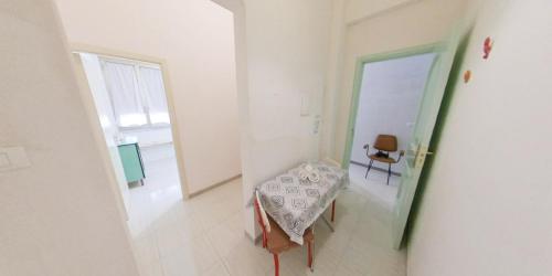a room with a table and a chair in it at Stella Maris Marzamemi Apartments in Marzamemi