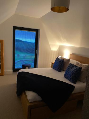 a bedroom with a bed with a large window at The DeerView Lodge in Cardiff