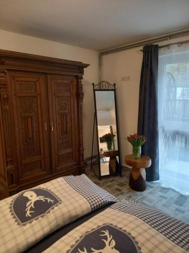 a bedroom with two beds and a dresser and a mirror at Holiday Oasis Appartements in Villach