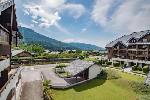 an aerial view of the courtyard of a house with mountains in the background at Studio Ella au cœur du village in Samoëns