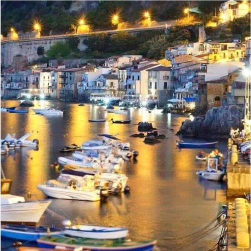 a group of boats docked in a harbor at night at Al Quindici Scilla in Scilla