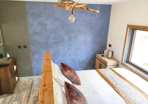 a bedroom with a bed with a ceiling fan at Villa Occitana in Calvisson