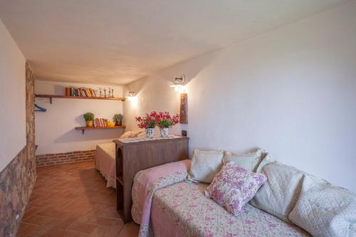 a living room with a couch and a table at Casa nel Bosco in Sassetta