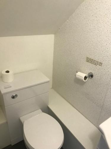 a white toilet sitting next to a white sink at Gothenburg Hotel in Rosyth