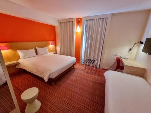 a hotel room with a bed and a desk at ibis Styles Le Puy en Velay in Le Puy en Velay
