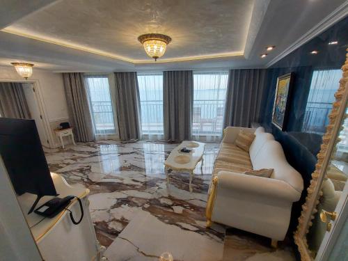 a living room with a couch and a mirror at Art Complex Anel in Sozopol