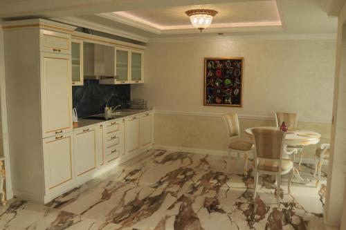 a kitchen with a table and a dining room at Art Complex Anel in Sozopol