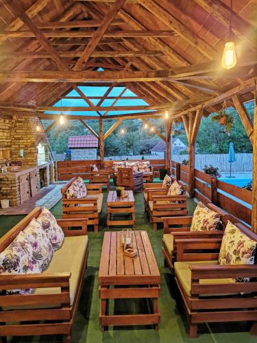 a restaurant with wooden benches and tables in a building at Kucerak111 in Vrdnik