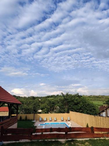 a swimming pool in a backyard with a cloudy sky at Kucerak111 in Vrdnik