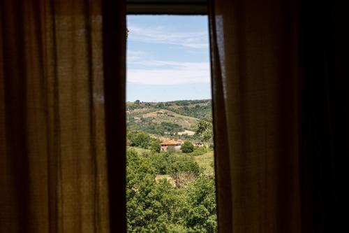 a window with a view of a mountain at Sorelle Biologiche in Monte Castello di Vibio