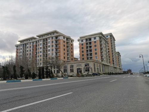 two tall buildings on the side of a road at Sumqayıt bulvarı in Sumqayyt