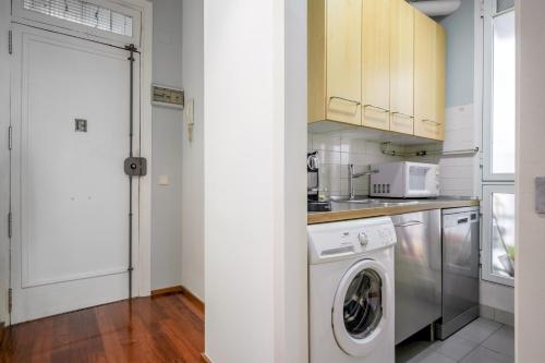 a kitchen with a washer and dryer in it at 2 bedrooms 1 bathroom furnished - Anton Martin - Vintage - MintyStay in Madrid