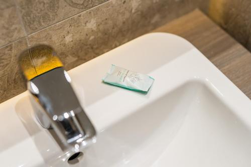 a close up of a faucet on a toilet at SeaPark Hotel Wellness & Spa in Kołobrzeg