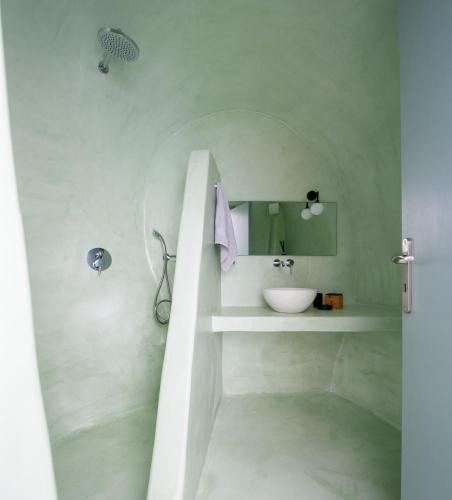 a white bathroom with a sink and a mirror at Sublime Villa & Caves in Akrotiri