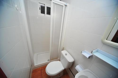 un bagno bianco con wc e doccia di Orange Park Duplex Atico Familiar a Benicàssim