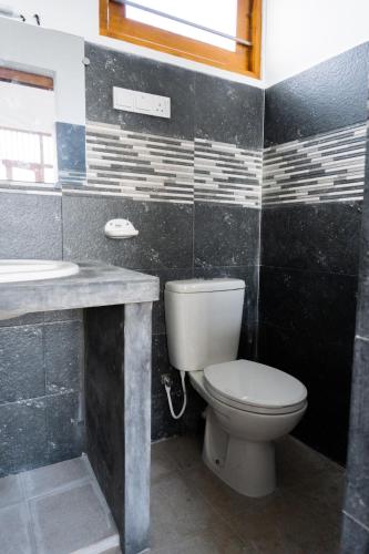 a bathroom with a toilet and a sink at La Polena in Matara