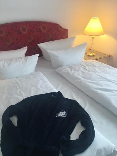 a black jacket laying on top of a bed at Alexander am Zoo in Frankfurt/Main