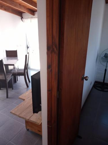 a door leading into a room with a table at La cabaña 5y15 in Playa Hermosa