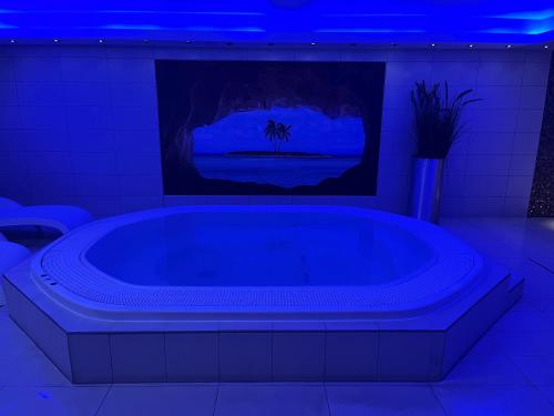 a large bath tub with a tv in a room at Mercure Hotel Brussels Centre Midi in Brussels