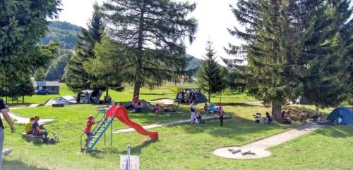 a group of people in a park with a playground at Apartment Gaia in Lokve