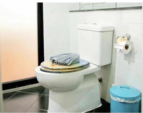 a bathroom with a white toilet with a towel on it at AT SEA Patong in Patong Beach