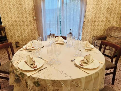 a table with glasses and plates and napkins on it at LE RADICI in Civitella dʼAgliano