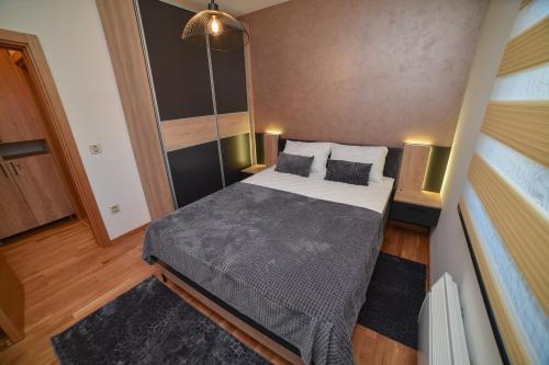 a small bedroom with a bed in a room at Aria Club Wellness&Spa Zlatibor in Zlatibor