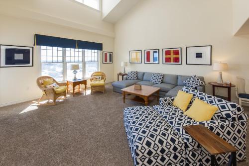 a living room with a couch and a table at The Sandbridge Dunes - Captains' Quarters 408 in Virginia Beach