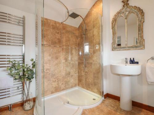 a bathroom with a shower and a sink at Hope Cottage in Bakewell